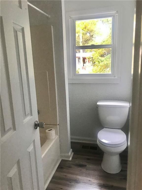 bathroom with toilet and hardwood / wood-style floors