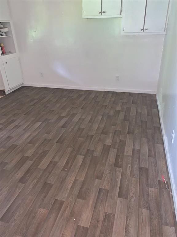 spare room with dark hardwood / wood-style flooring