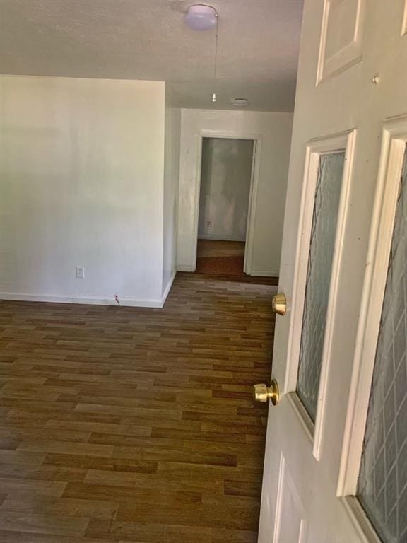 spare room with dark hardwood / wood-style floors