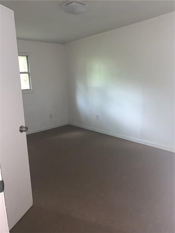 unfurnished room featuring concrete floors