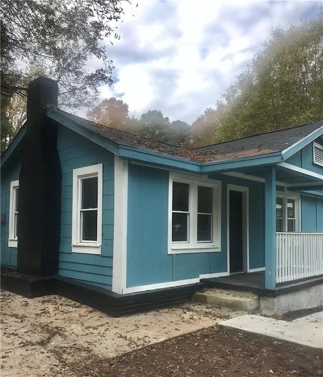 view of side of home featuring a porch