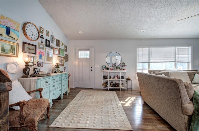 entrance foyer featuring dark wood-style flooring, a textured ceiling, and baseboards