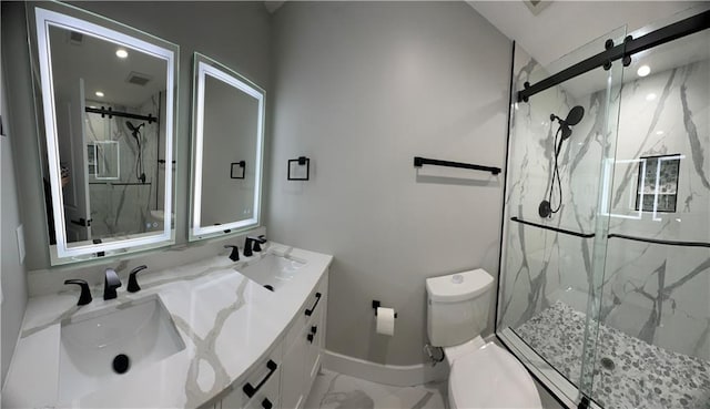 bathroom featuring vanity, an enclosed shower, and toilet