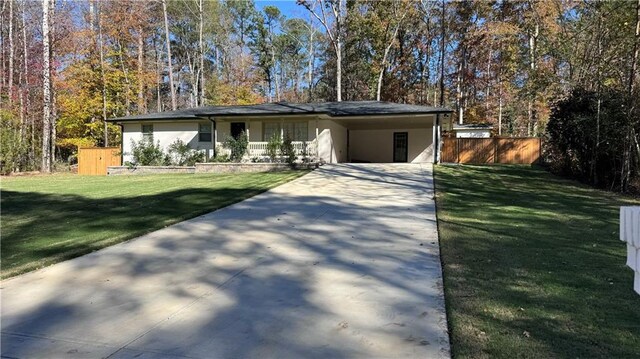 single story home featuring a front lawn and a carport