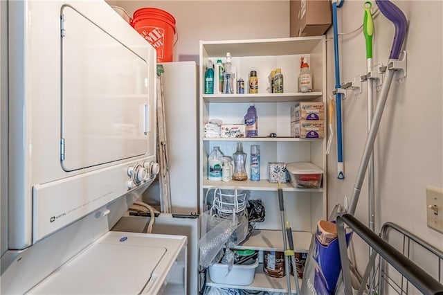 laundry room with stacked washer / drying machine and laundry area