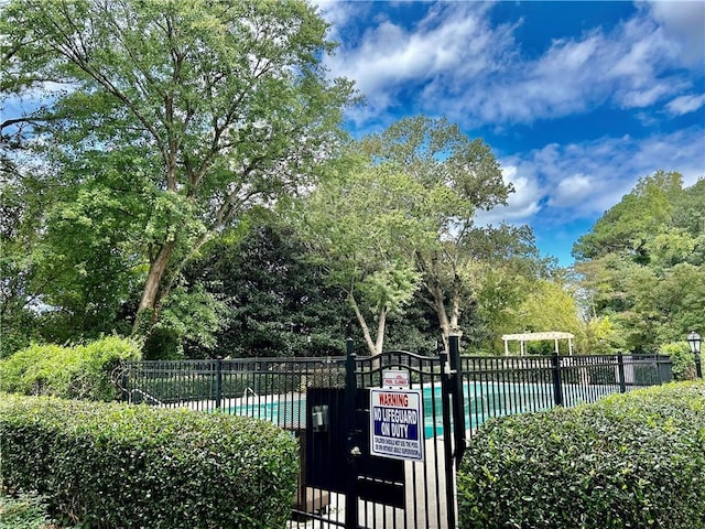 exterior space with a pool and fence