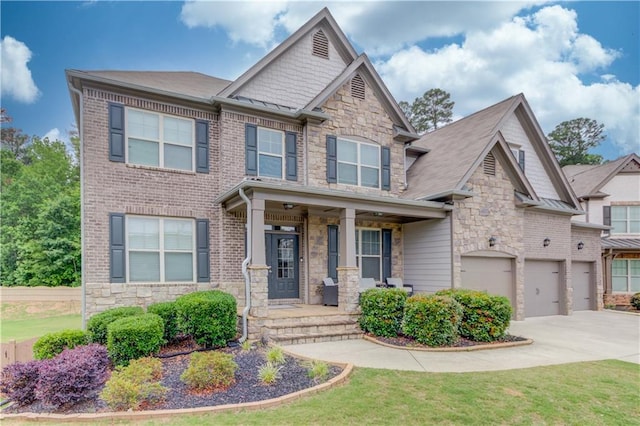 4240 Summer Breeze Way, Buford, GA 30518 - craftsman-style home featuring stone siding, driveway, an attached garage, covered porch, and a front yard