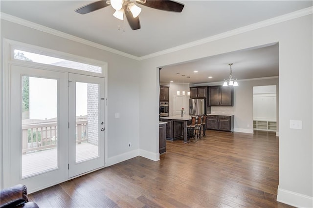 4240 Summer Breeze Way, Buford, GA 30518 - living room featuring a ceiling fan, dark wood-style flooring, baseboards, and crown molding