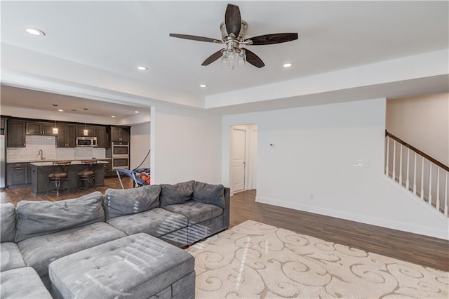 4240 Summer Breeze Way, Buford, GA 30518 - living room featuring recessed lighting, dark wood-style floors, ceiling fan, stairway, and baseboards