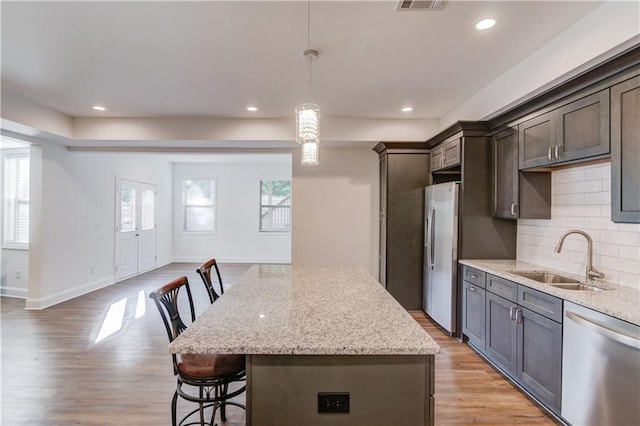 4240 Summer Breeze Way, Buford, GA 30518 - kitchen with a sink, appliances with stainless steel finishes, light wood-type flooring, backsplash, and recessed lighting