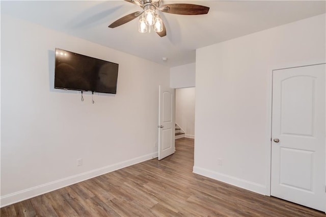 4240 Summer Breeze Way, Buford, GA 30518 - unfurnished bedroom featuring wood finished floors, baseboards, and a ceiling fan