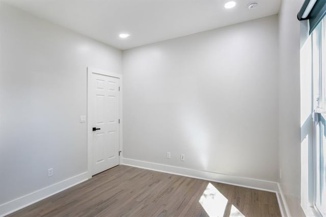 unfurnished room featuring hardwood / wood-style flooring