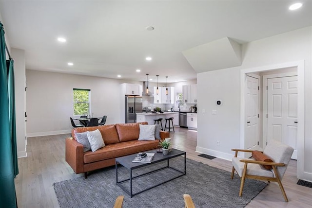 living room with light hardwood / wood-style flooring