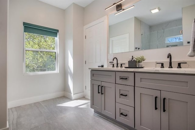 bathroom with a shower with door and vanity