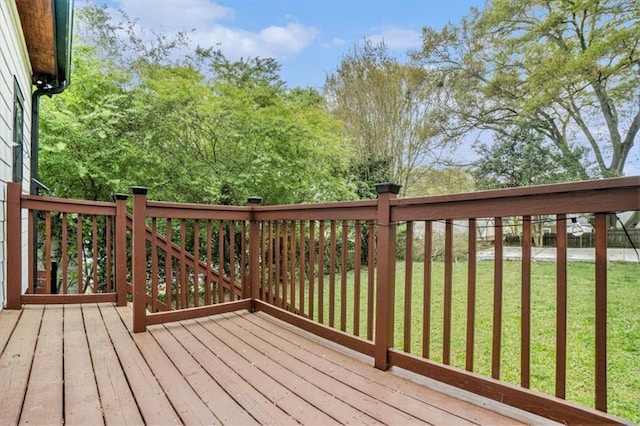 wooden deck featuring a yard