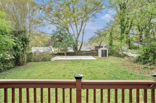 view of yard featuring a storage shed and a patio