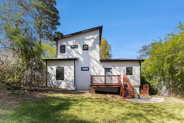 rear view of house with a yard and a deck