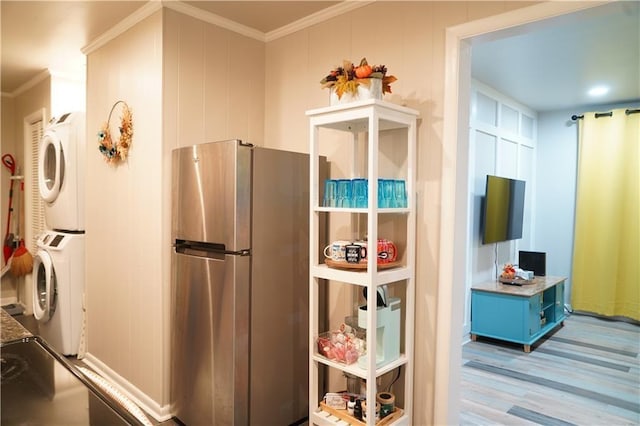1452 Mercer Ave, Atlanta, GA 30337 - kitchen featuring freestanding refrigerator, estacked washer and dryer, crown molding, wood finished floors, and stove