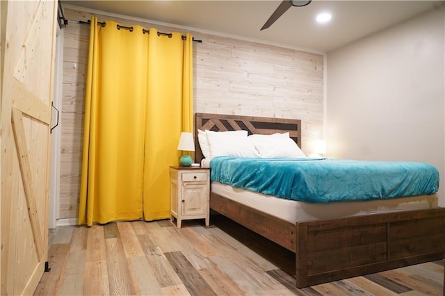 1452 Mercer Ave, Atlanta, GA 30337 - bedroom with light wood-style flooring, wooden walls, recessed lighting, and a ceiling fan