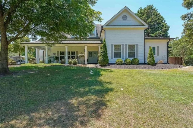 back of property with a porch and a yard