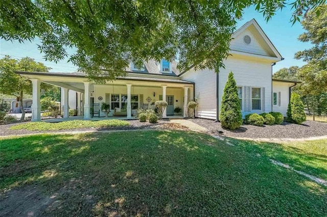 rear view of house featuring a porch and a yard