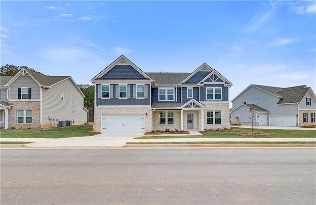 view of front facade with concrete driveway, central AC unit, board and batten siding, a garage, and a residential view