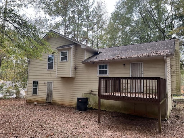 back of property featuring cooling unit and a deck