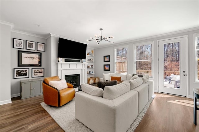 234 Retreat Ln, Canton, GA 30114 - living room featuring ornamental molding, wood finished floors, a glass covered fireplace, a chandelier, and baseboards