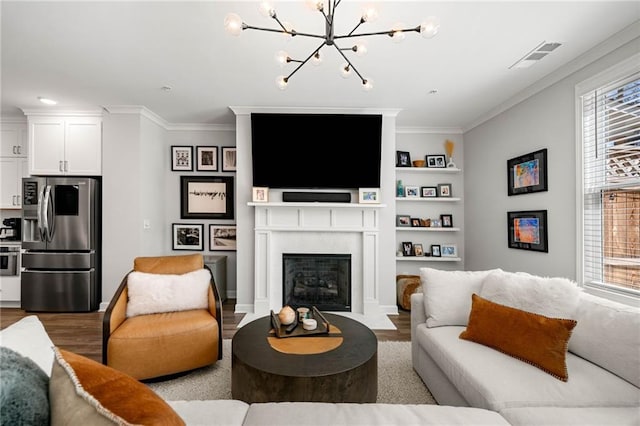 234 Retreat Ln, Canton, GA 30114 - living room featuring wood finished floors, a chandelier, ornamental molding, and a fireplace