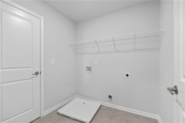 clothes washing area featuring light tile patterned flooring, washer hookup, and electric dryer hookup