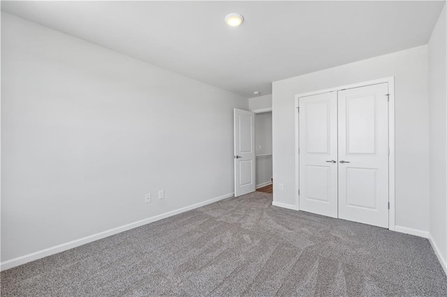 unfurnished bedroom with a closet and carpet flooring