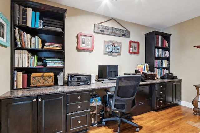 office space featuring baseboards and light wood-type flooring