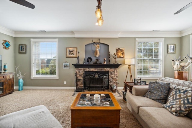 carpeted living room featuring a healthy amount of sunlight, ornamental molding, and a ceiling fan
