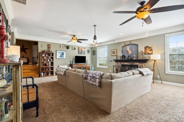 carpeted living room featuring crown molding, ceiling fan, and a healthy amount of sunlight