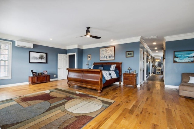 bedroom with a wall unit AC, baseboards, light wood-style floors, ornamental molding, and recessed lighting