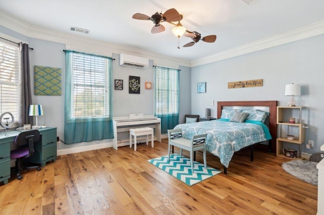 bedroom featuring multiple windows, visible vents, wood finished floors, an AC wall unit, and ornamental molding