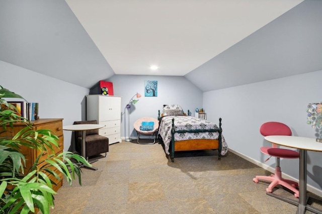 carpeted bedroom with baseboards and vaulted ceiling