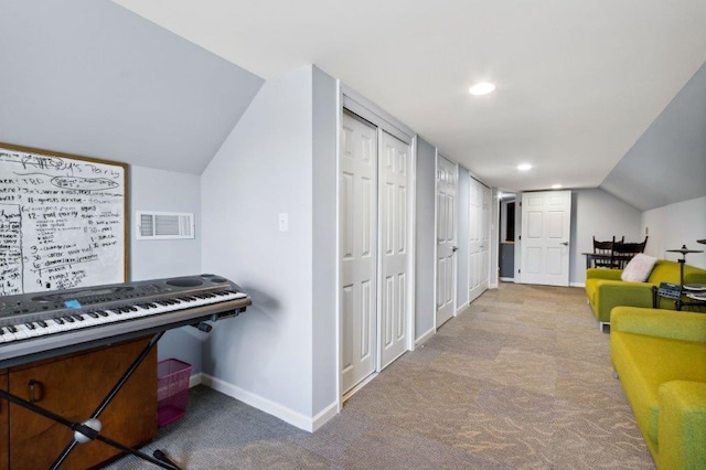 interior space featuring carpet flooring, baseboards, visible vents, and lofted ceiling