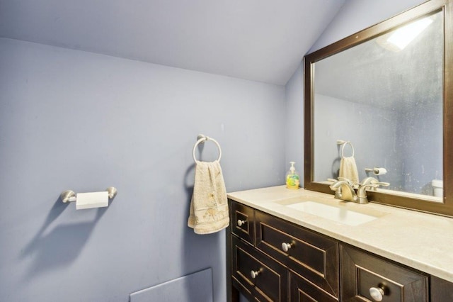 bathroom featuring vanity and vaulted ceiling