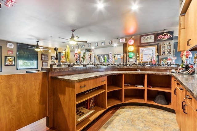 interior space with ceiling fan
