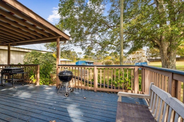 wooden terrace featuring area for grilling