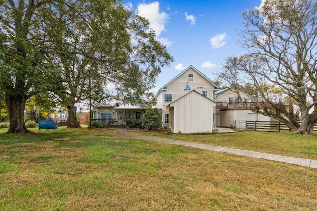 exterior space with a wooden deck and a front lawn
