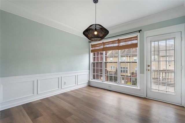 4855 Payson Ter SE Unit 3, Atlanta, GA 30339 - unfurnished dining area with crown molding, a wainscoted wall, wood finished floors, and a decorative wall