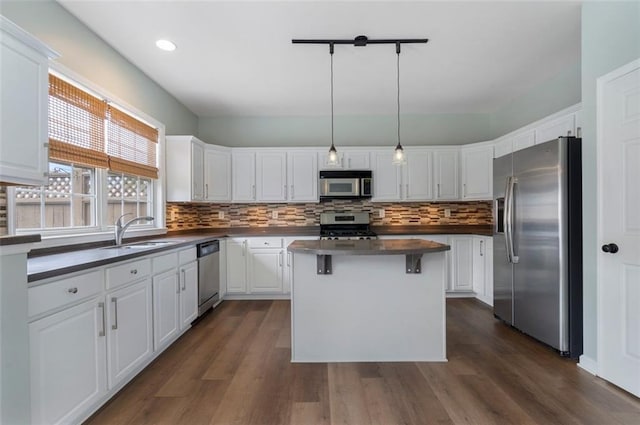 4855 Payson Ter SE Unit 3, Atlanta, GA 30339 - kitchen with stainless steel appliances, a sink, dark countertops, white cabinetry, and tasteful backsplash