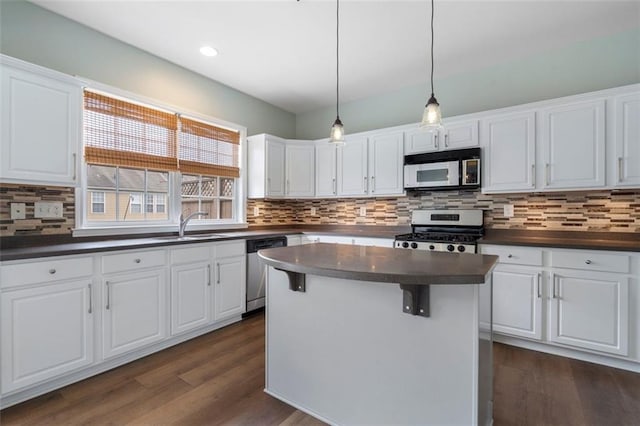 4855 Payson Ter SE Unit 3, Atlanta, GA 30339 - kitchen featuring appliances with stainless steel finishes, dark countertops, white cabinetry, a sink, and tasteful backsplash