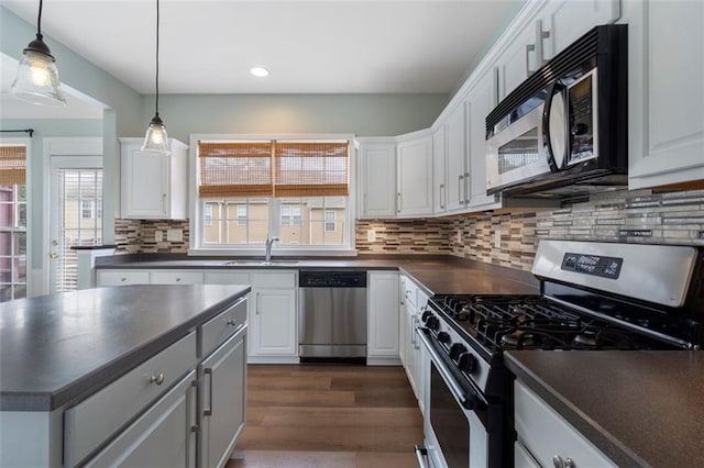 4855 Payson Ter SE Unit 3, Atlanta, GA 30339 - kitchen featuring appliances with stainless steel finishes, dark countertops, a sink, plenty of natural light, and recessed lighting