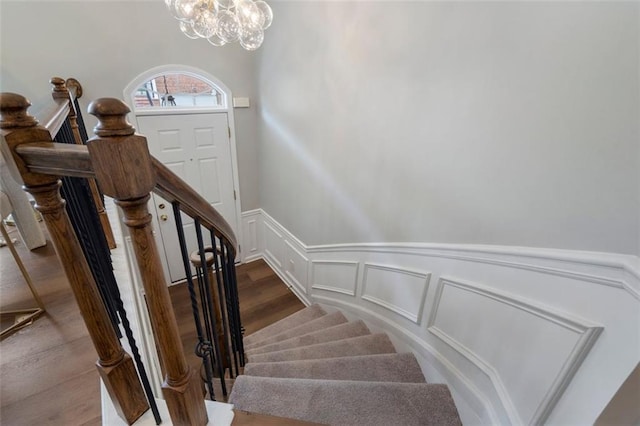 4855 Payson Ter SE Unit 3, Atlanta, GA 30339 - stairway with a decorative wall, a chandelier, and a wainscoted wall