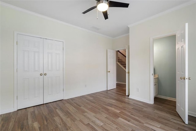 4855 Payson Ter SE Unit 3, Atlanta, GA 30339 - unfurnished bedroom with crown molding, wood finished floors, a closet, baseboards, and ceiling fan