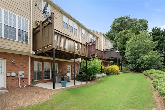4855 Payson Ter SE Unit 3, Atlanta, GA 30339 - rear view of house featuring a lawn, a patio, brick siding, central air condition unit, and a deck