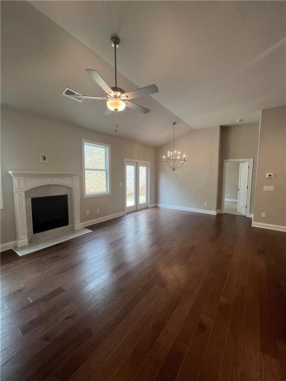 unfurnished living room featuring a fireplace, dark hardwood / wood-style flooring, ceiling fan with notable chandelier, and vaulted ceiling